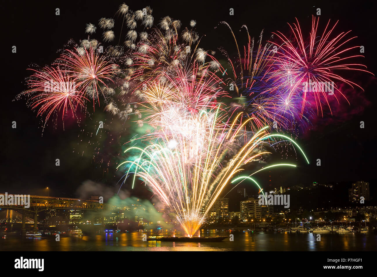 4th of July Independence Day fireworks display along Willamette River in downtown Portland Oregon waterfront Stock Photo