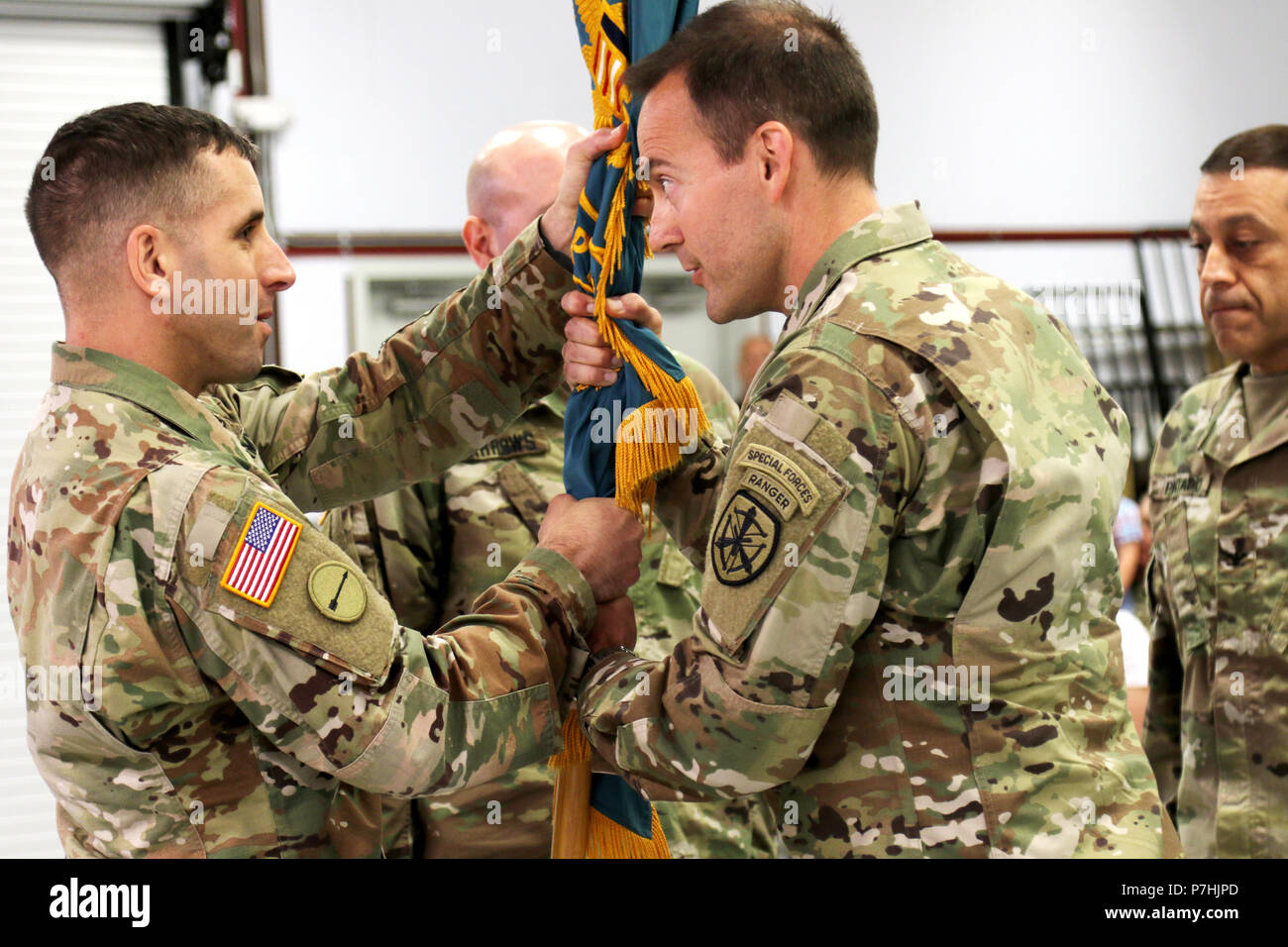 U.S. Army Marksmanship Unit's Command Sgt. Maj. Jason Levy accepts the  battalion colors from his new commander, Lt. Col. Harris Lawrence during a  Change of Command Ceremony at Fort Benning, Georgia June