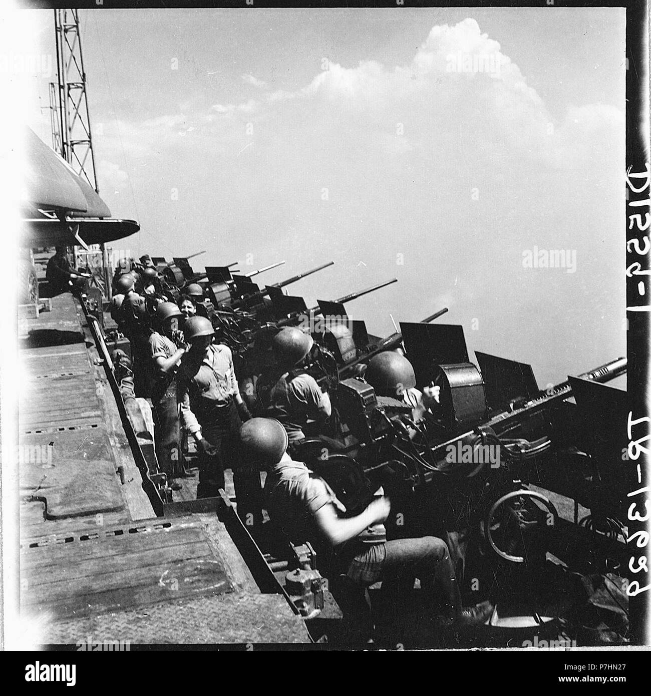 20mm gun crews standing by aboard the USS Hornet (CV-12) as her planes hit Tokyo, Japan Stock Photo