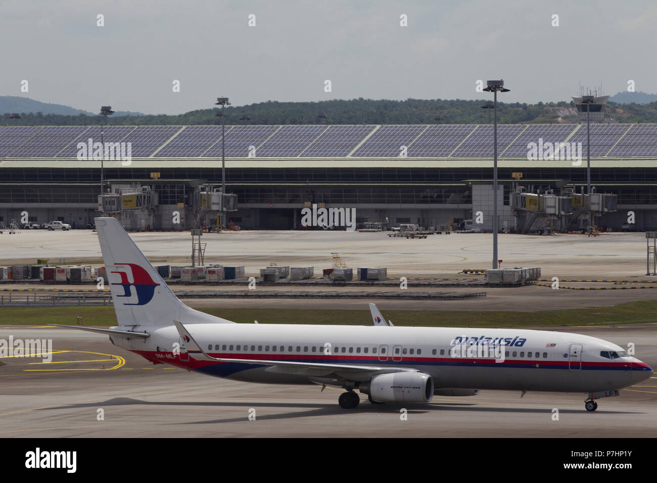 A Malaysian Airlines Boeing 737 taxis to the terminal building after landing at Kuala Lumpur International Airport in Malaysia. Stock Photo