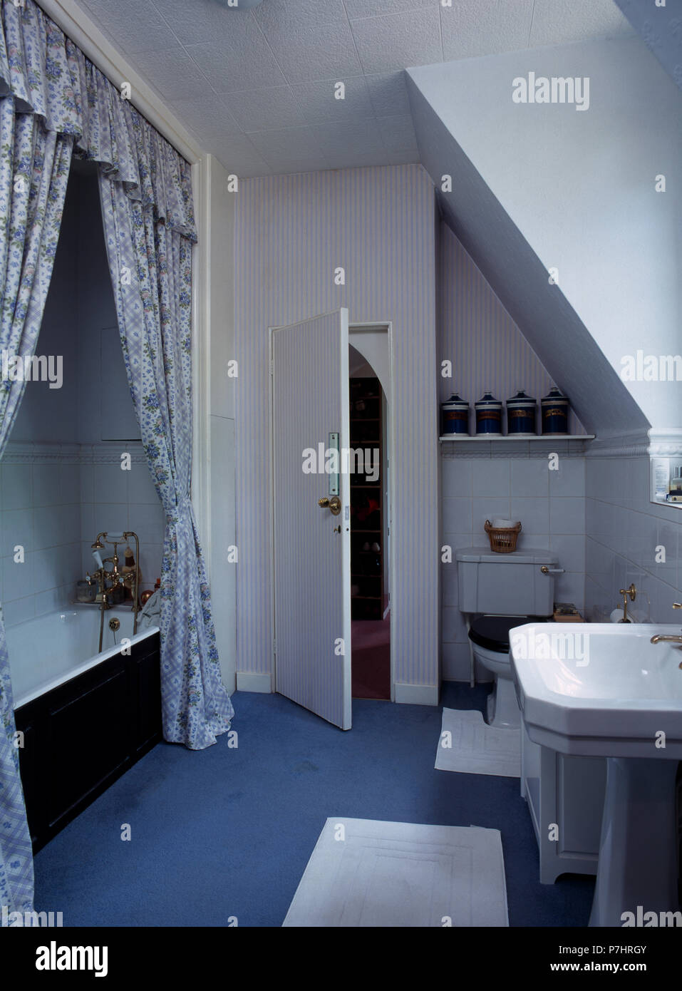 Blue Floral Drapes Above Bath In Old Fashioned Attic Bathroom With