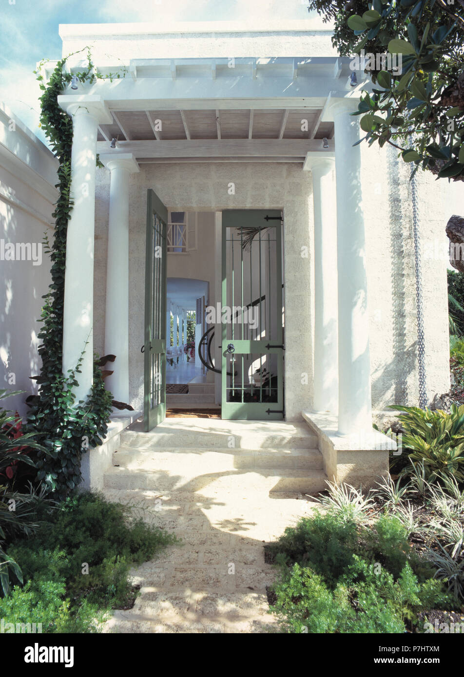 Steps up to pillared porch of Caribbean house Stock Photo