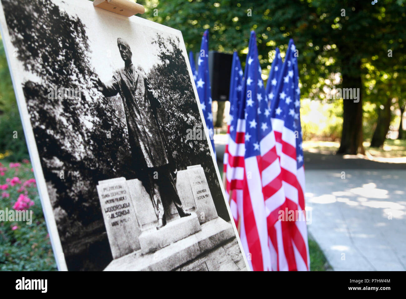 A photo display of a previous sculpture in honor of President Woodrow  Wilson stands in front of the current monument July 4, 2018, ahead of a  ceremony at Wilson Park in Poznań,