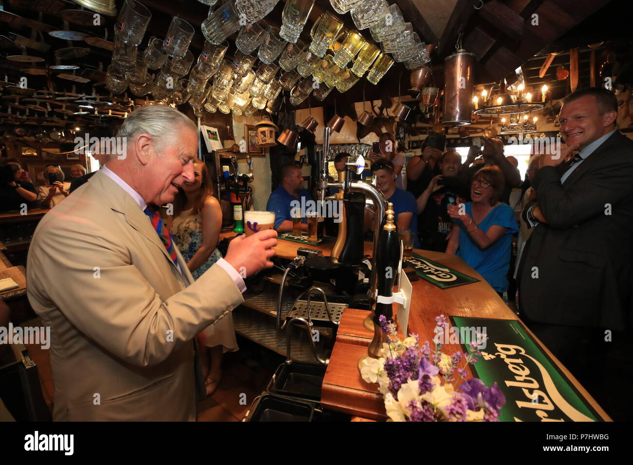 The Prince of Wales pours a pint of Snowdonia ale in the Old Stag pub in Llangernyw, Abergele during his five day visit to Wales. Stock Photo