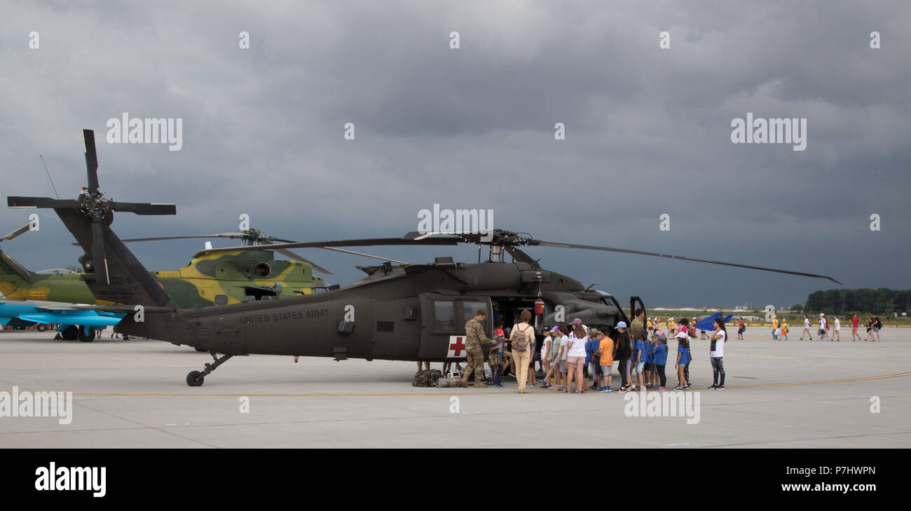 U.S. Soldiers assigned to the 2nd General Support Aviation Battalion, 4th Aviation Regiment, 4th Combat Aviation Brigade, 4th Infantry Division, participate in a multinational static display for school-aged children of the region at Mihail Koglniceanu Air Base, Romania, July 5, 2018. Soldiers of the battalion are in Romania conducting a nine-month deployment in support of Atlantic Resolve, a U.S. endeavor to fulfill NATO commitments by rotating U.S.-based units throughout the European theater to deter aggression against NATO allies and partners in Europe. (U.S. Army photo by Spc. Andrew McNeil Stock Photo