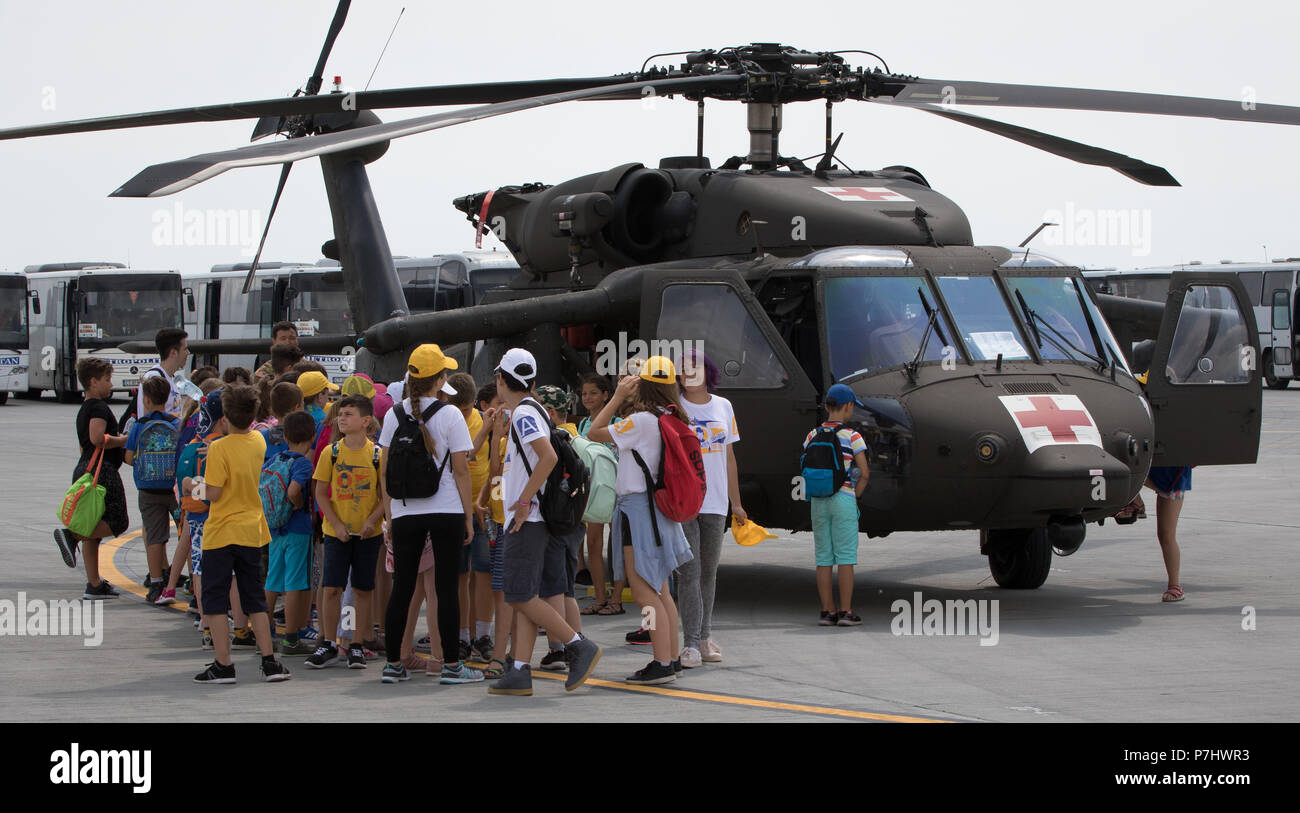 U.S. Soldiers assigned to the 2nd General Support Aviation Battalion, 4th Aviation Regiment, 4th Combat Aviation Brigade, 4th Infantry Division, participate in a multinational static display for school-aged children of the region at Mihail Koglniceanu Air Base, Romania, July 5, 2018. Soldiers of the battalion are in Romania conducting a nine-month deployment in support of Atlantic Resolve, a U.S. endeavor to fulfill NATO commitments by rotating U.S.-based units throughout the European theater to deter aggression against NATO allies and partners in Europe. (U.S. Army photo by Spc. Andrew McNeil Stock Photo