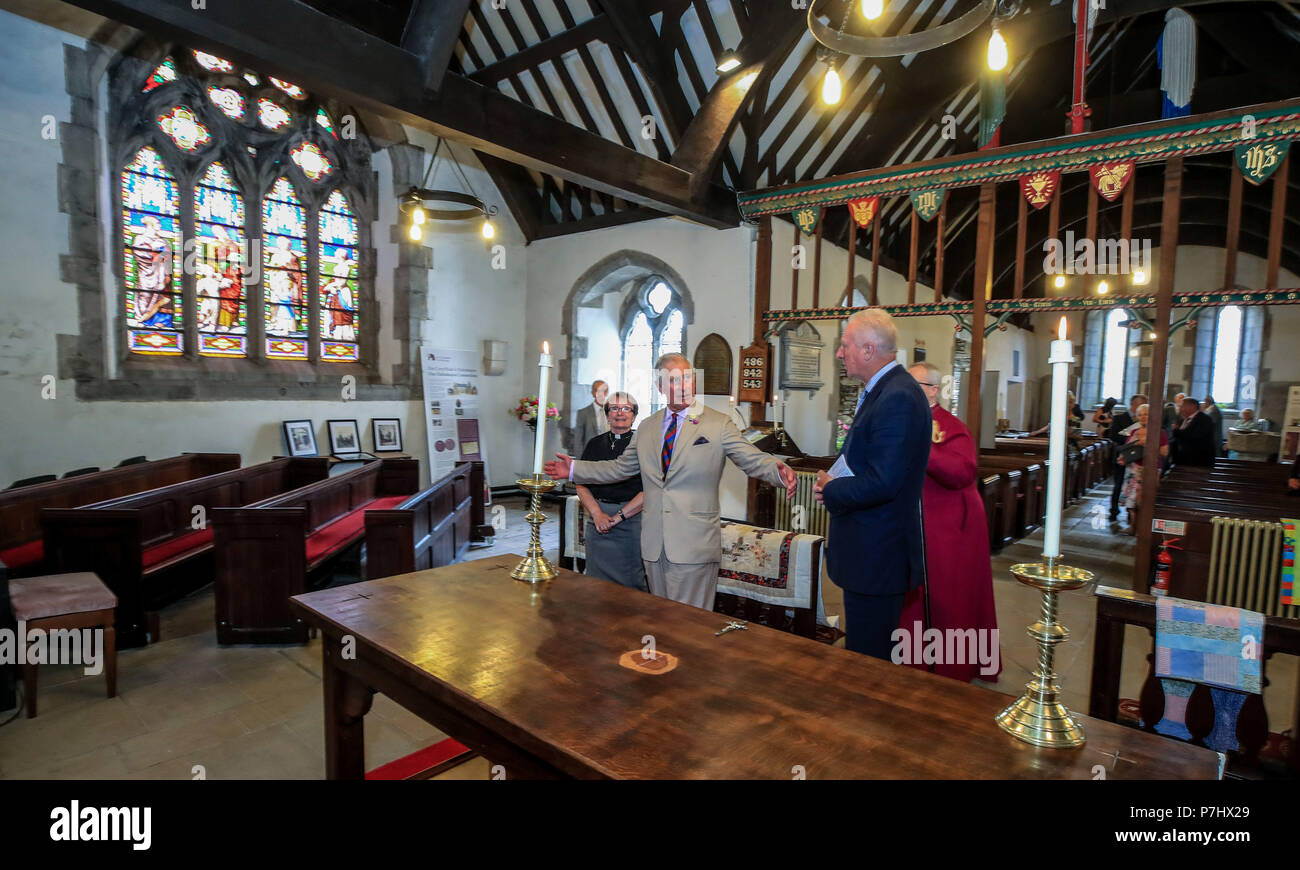 The Prince of Wales looks at the piece of Yew Tree that forms part of the altar in the St Digain Church in Llangernyw, Abergele during his five day visit to Wales. Stock Photo