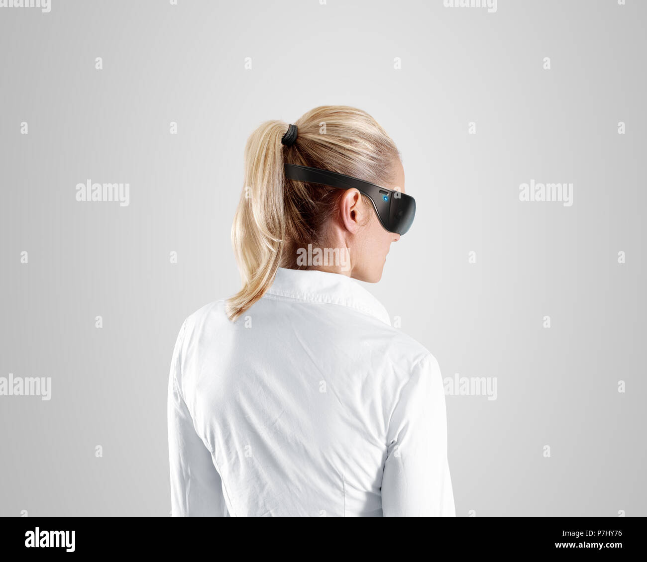 Virtual reality glasses, wear on woman, isolated, clipping path. Shirt person stand back looking in 3d cyber headset display. Wearable vr computer hea Stock Photo