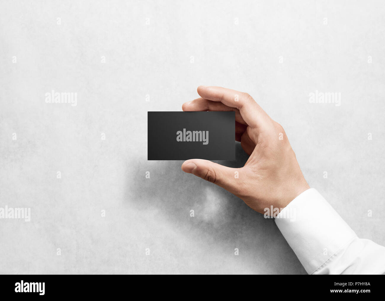 Hand hold blank plain black business card design mockup. Clear namecard
