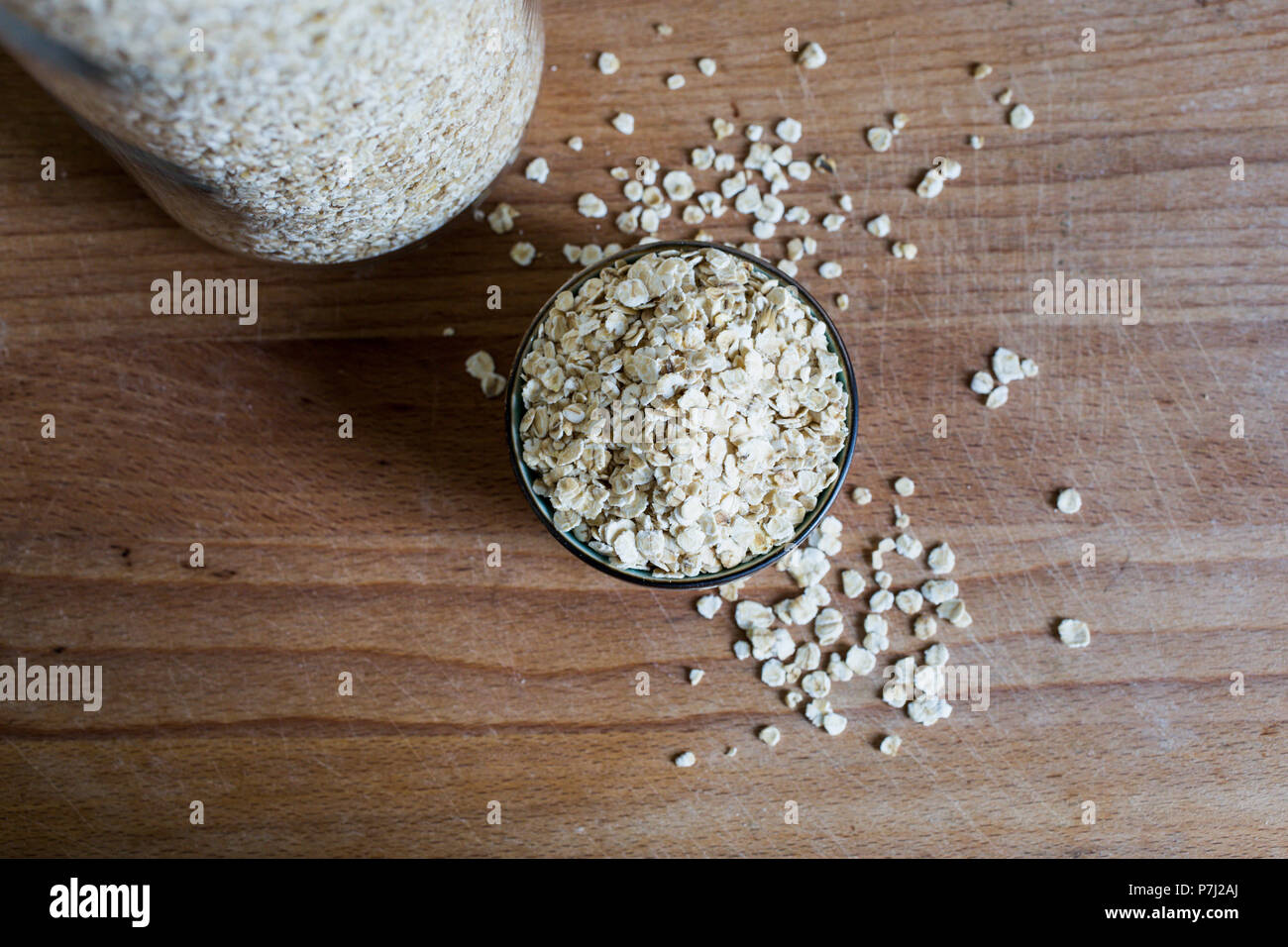 fibre source natural oat flakes for whole food diet on wooden table Stock Photo
