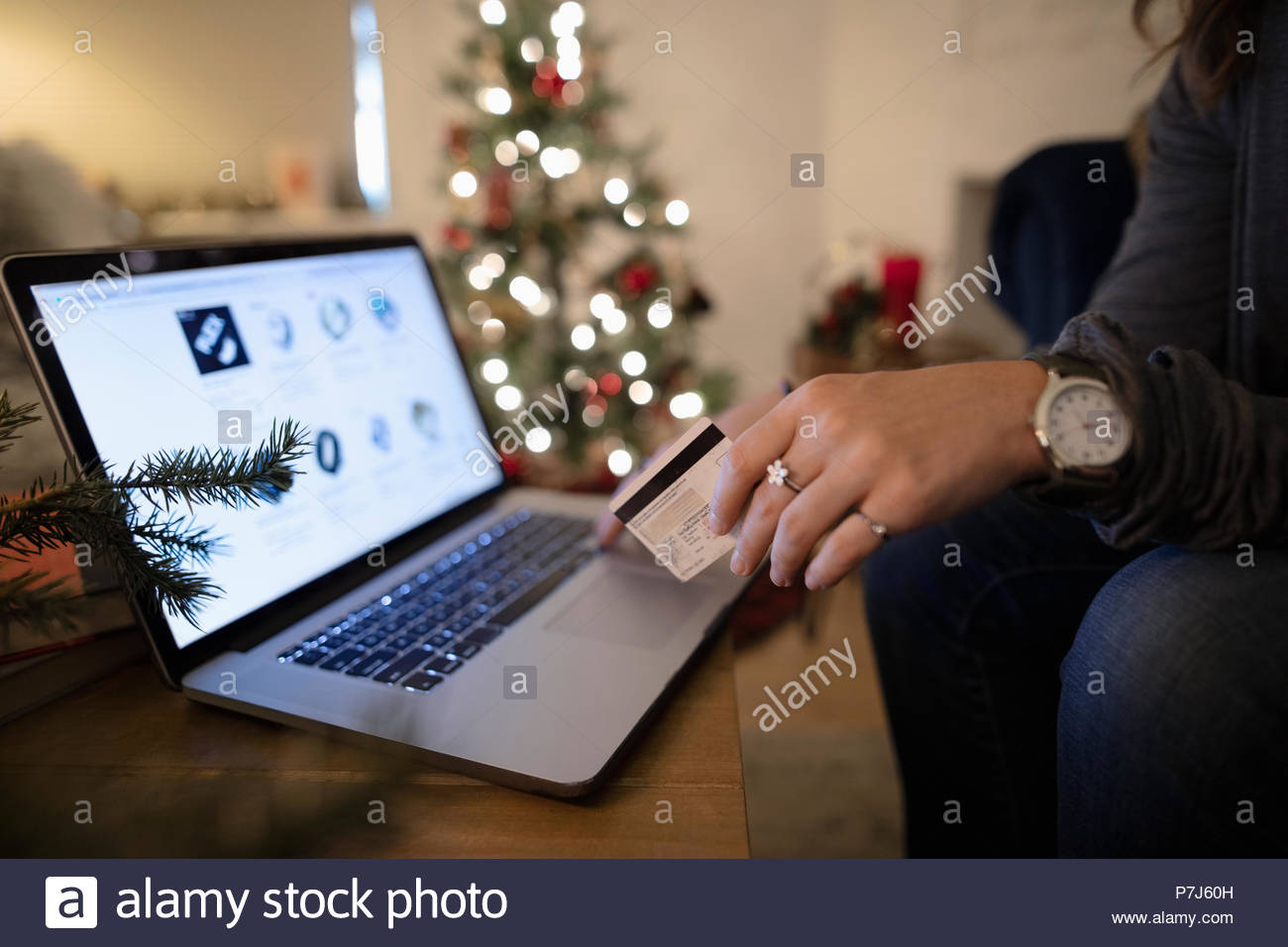 Close up young woman online Christmas shopping at laptop Stock Photo