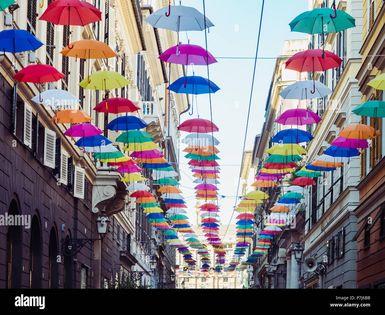 Multicolored, bright umbrellas hanging between houses on the beautiful,  narrow streets of the magnificent city of Genoa against the blue sky, on a  sun Stock Photo - Alamy