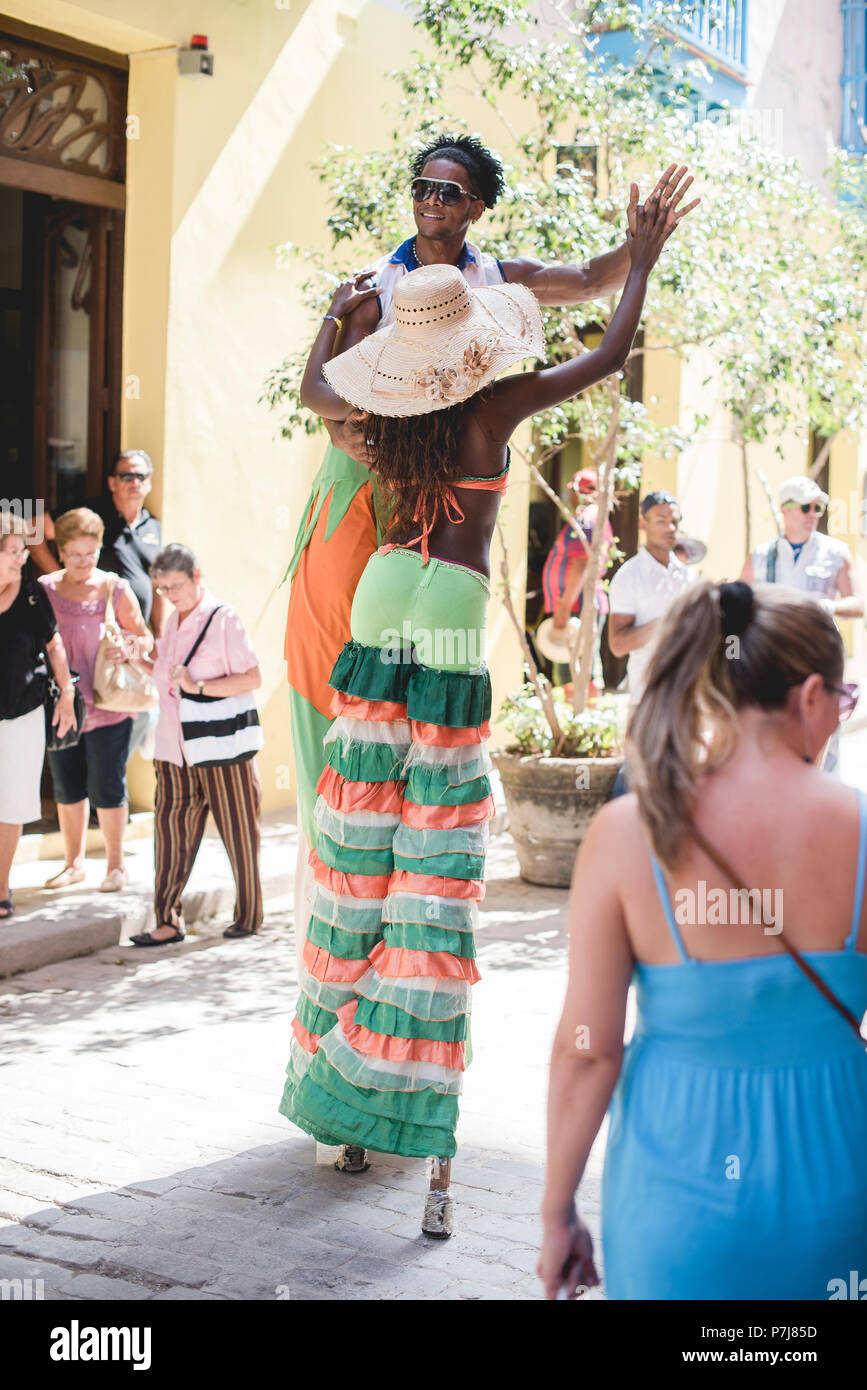 A street performance with stilt dancers and musicians in historic ...
