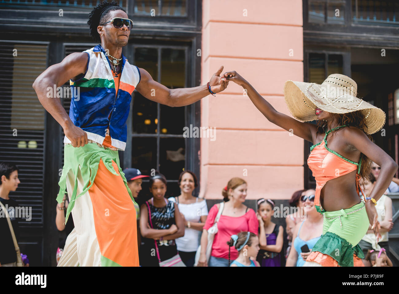 A street performance with stilt dancers and musicians in historic ...