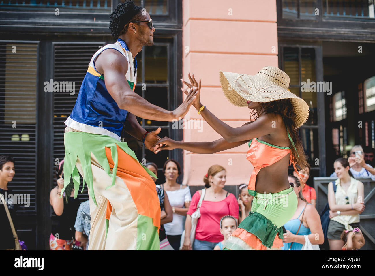 A street performance with stilt dancers and musicians in historic ...