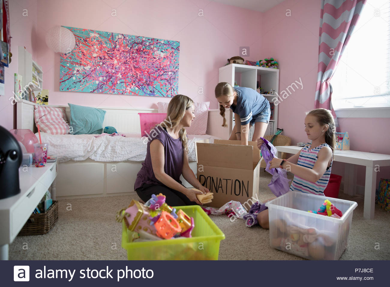 Mother and daughters organizing bedroom, donating Stock Photo Alamy