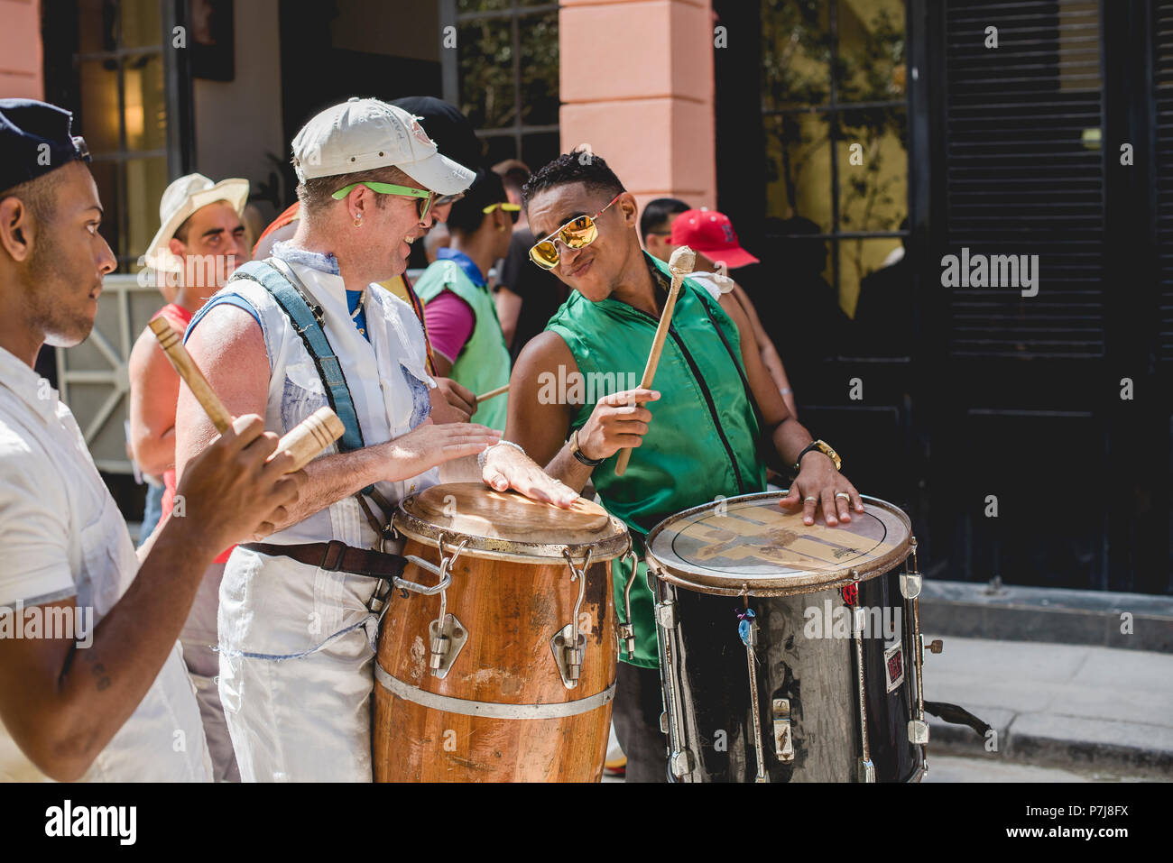 A street performance with stilt dancers and musicians in historic ...