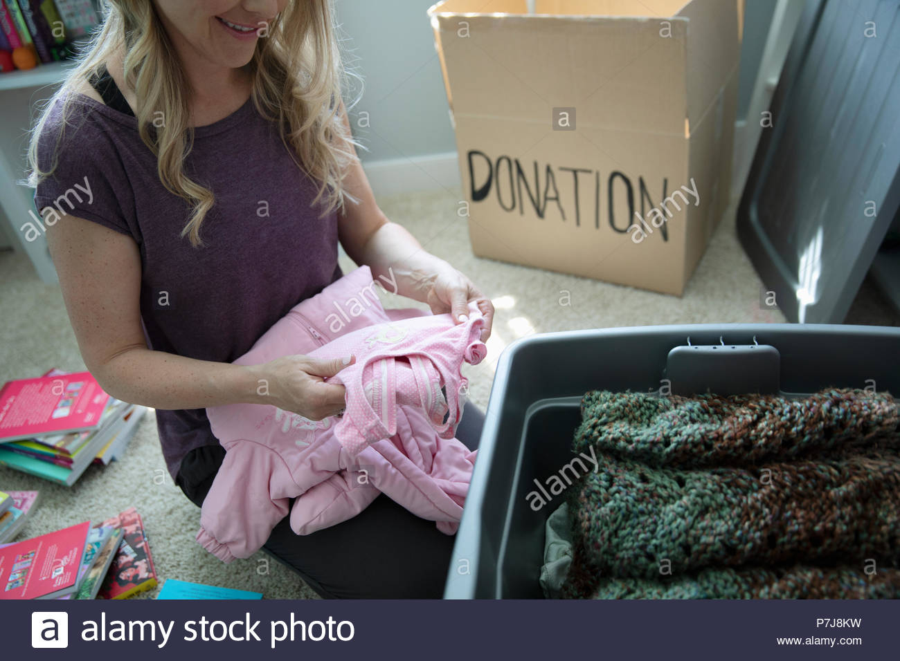 Donating baby clothes hi-res stock photography and images - Alamy