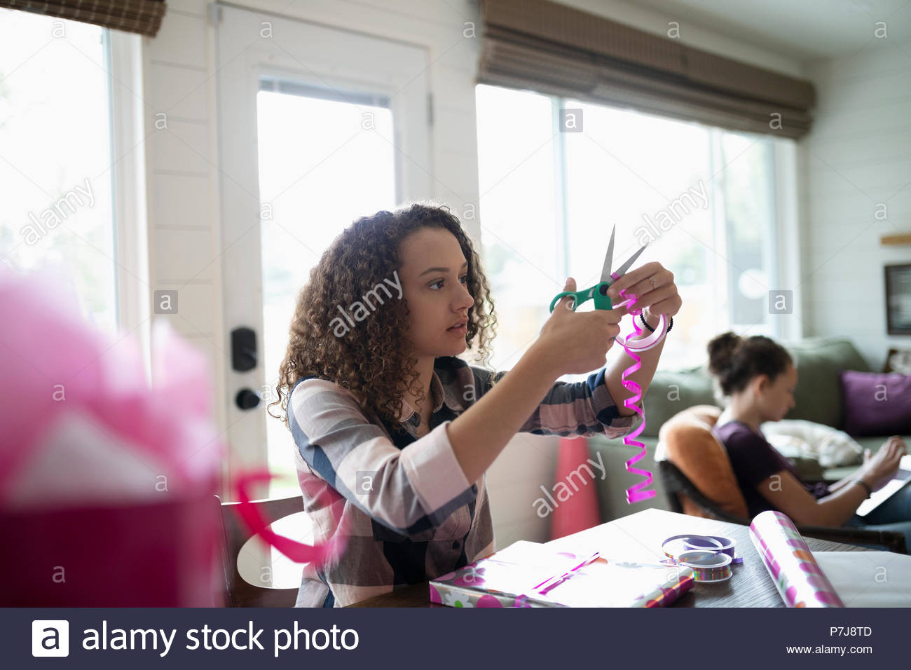 Teenage girl wrapping birthday gift Stock Photo Alamy