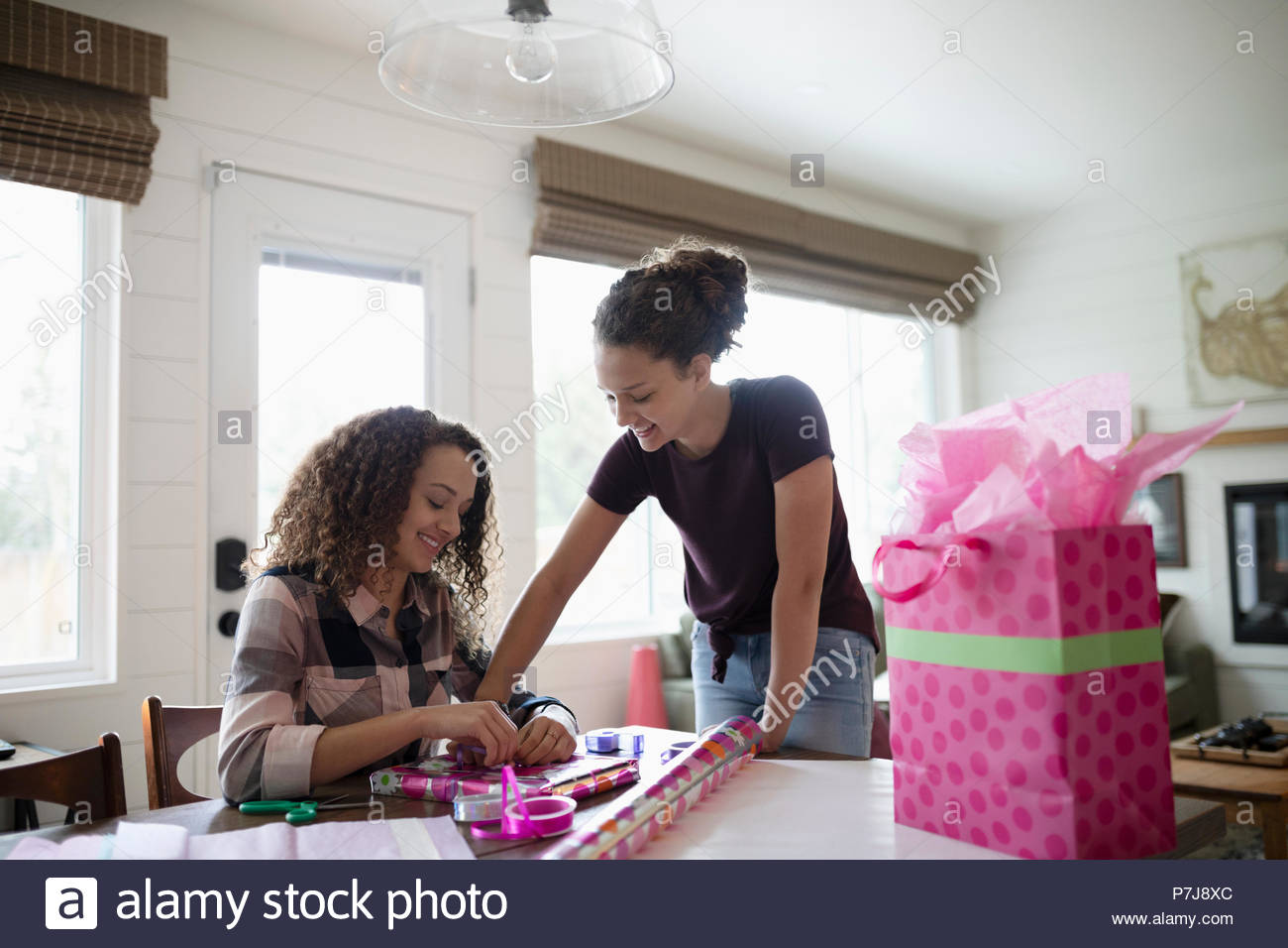 Teenage girls wrapping birthday gift Stock Photo Alamy