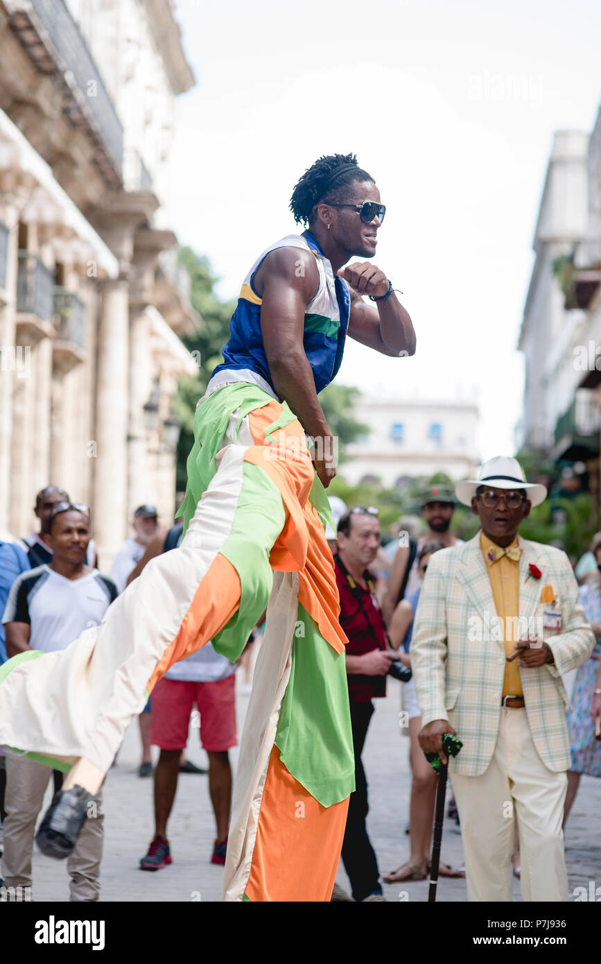 A street performance with stilt dancers and musicians in historic ...
