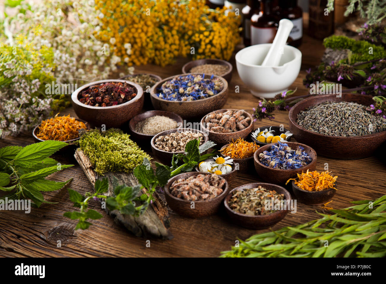 Natural remedy and mortar, healing herbs background Stock Photo - Alamy