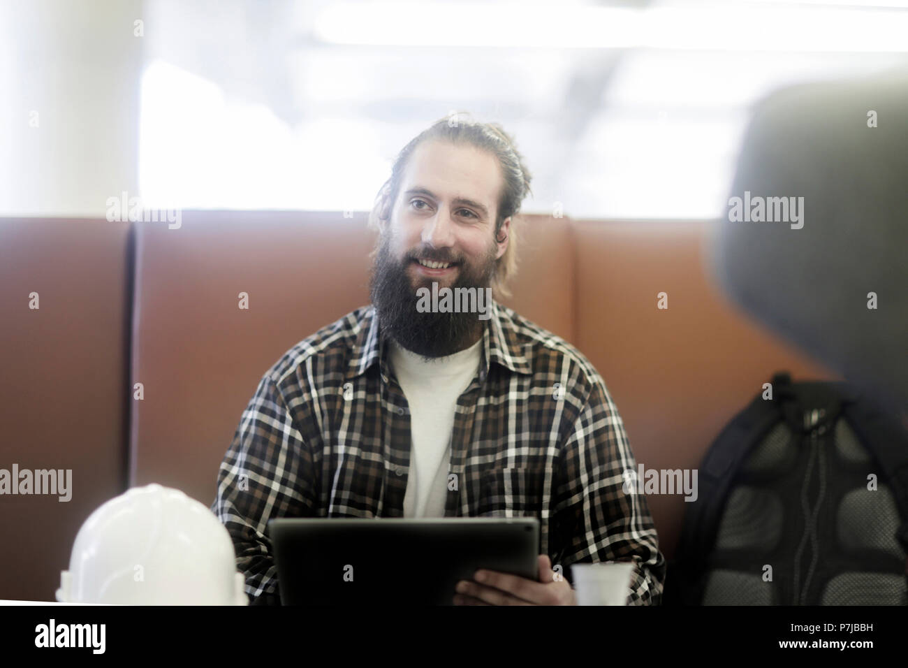 Man sitting couch smiling hi-res stock photography and images - Alamy