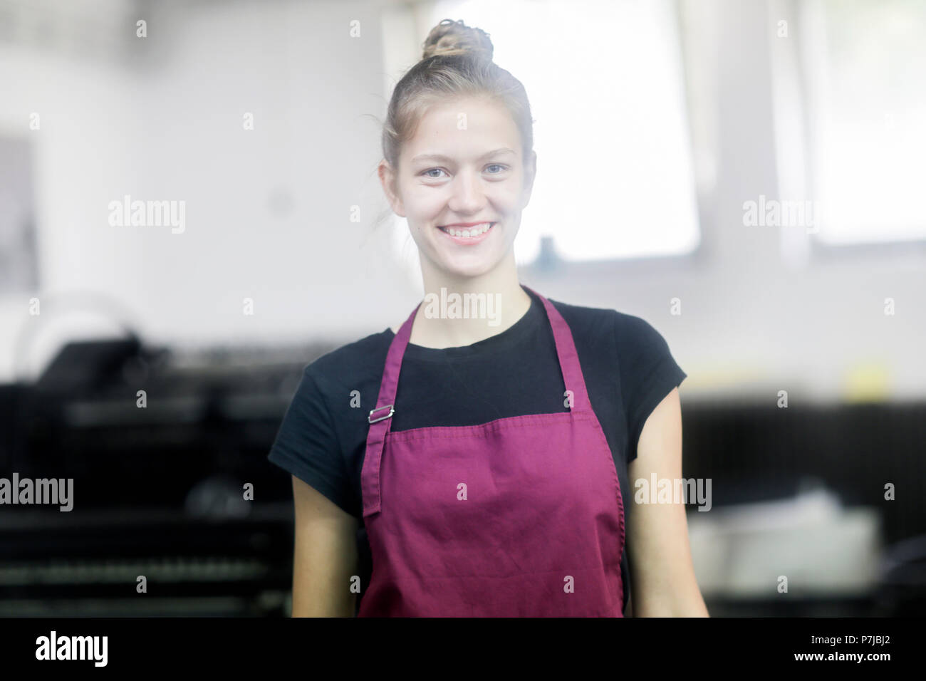 Portrait of a smiling woman in a factory Stock Photo