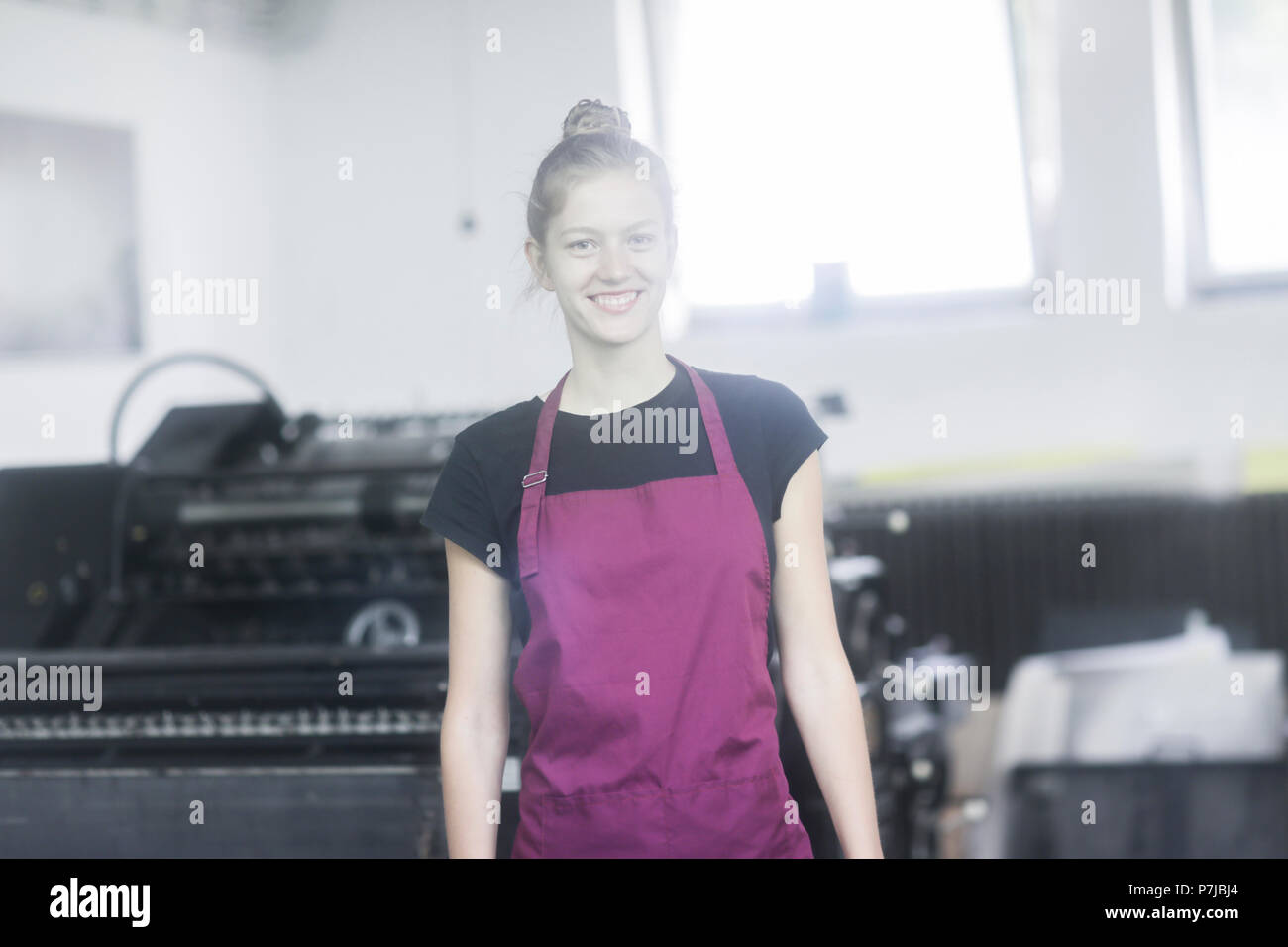 Portrait of a smiling woman in a factory Stock Photo