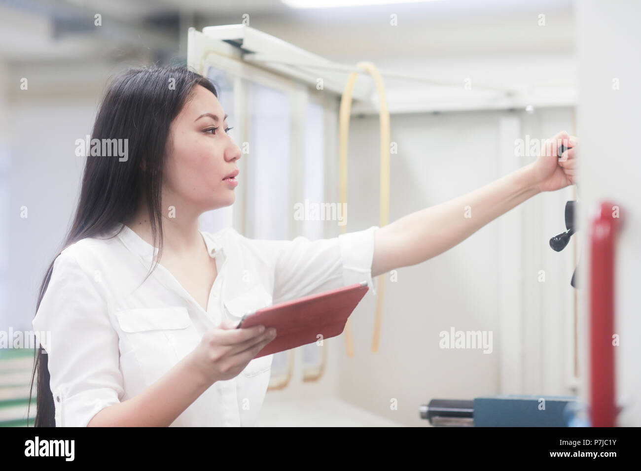 Female engineer holding a digital tablet Stock Photo