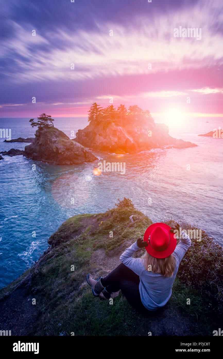 Woman standing on a cliff looking sea stacks, Samuel H Boardman State Park, Oregon, America, USA Stock Photo