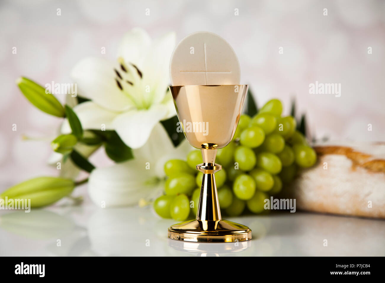 Holy Communion A Golden Chalice With Grapes And Bread Wafers Stock holy-communion-a-golden-chalice-with-grapes-and-bread-wafers-stock