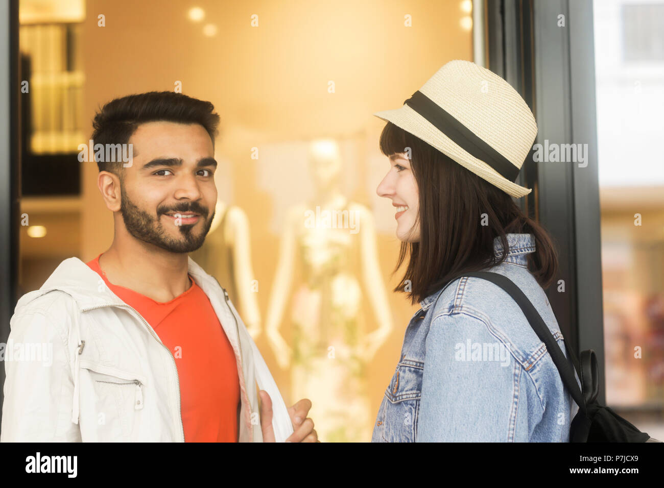 Smiling Couple standing outside a shop Stock Photo