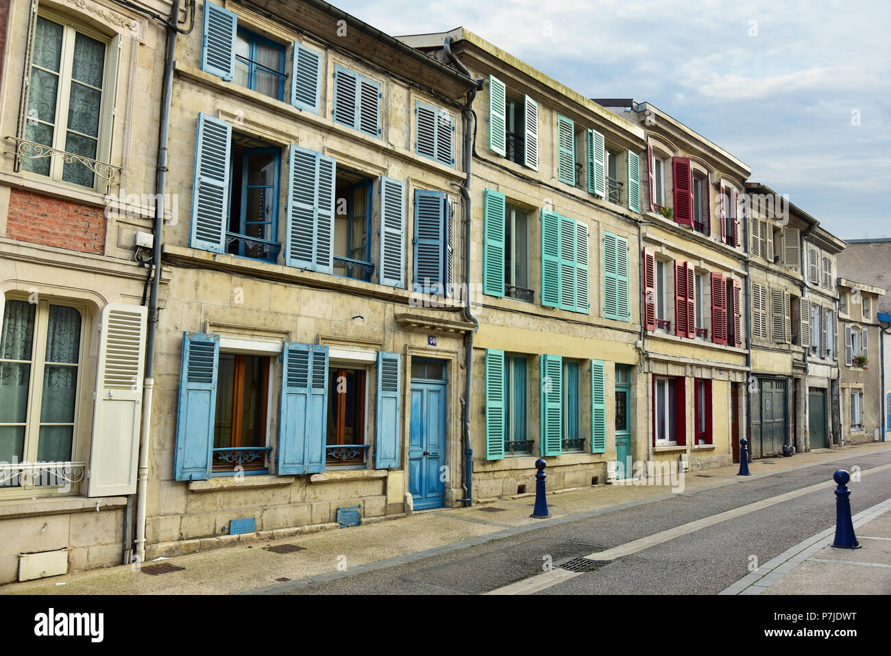 Houses with different colored window shutters in Verdun, France Stock