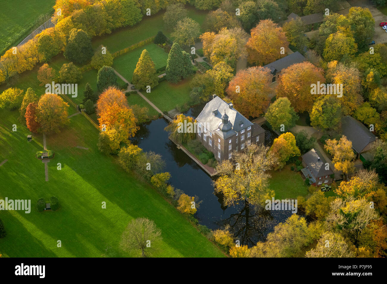 Haus Wohnung' moated castle in autumnal park, Voerde, Ruhr area Stock Photo