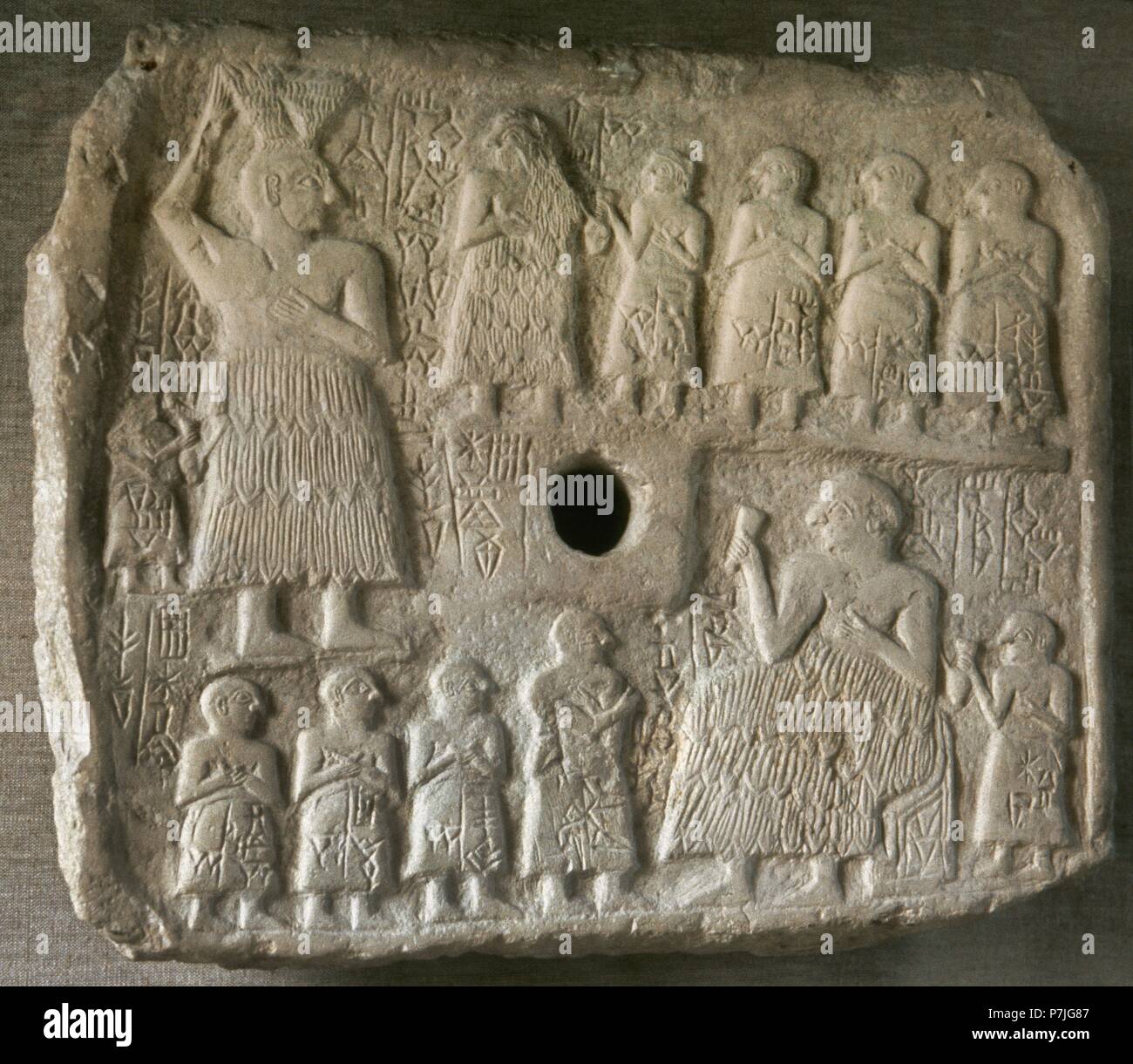 Perforated relief of King Ur-Nanshe, king of Lagash. Early Dynastic period III, c. 2550-2500 BC. Reliefs commemorating religious actions of the king Ur-Nanshe. He is depicted presiding over the ceremonies of the foundation and inauguration of a shrine. From Tello (ancient Girsu), Iraq. Limestone. Louvre Museum. Paris, France. Stock Photo