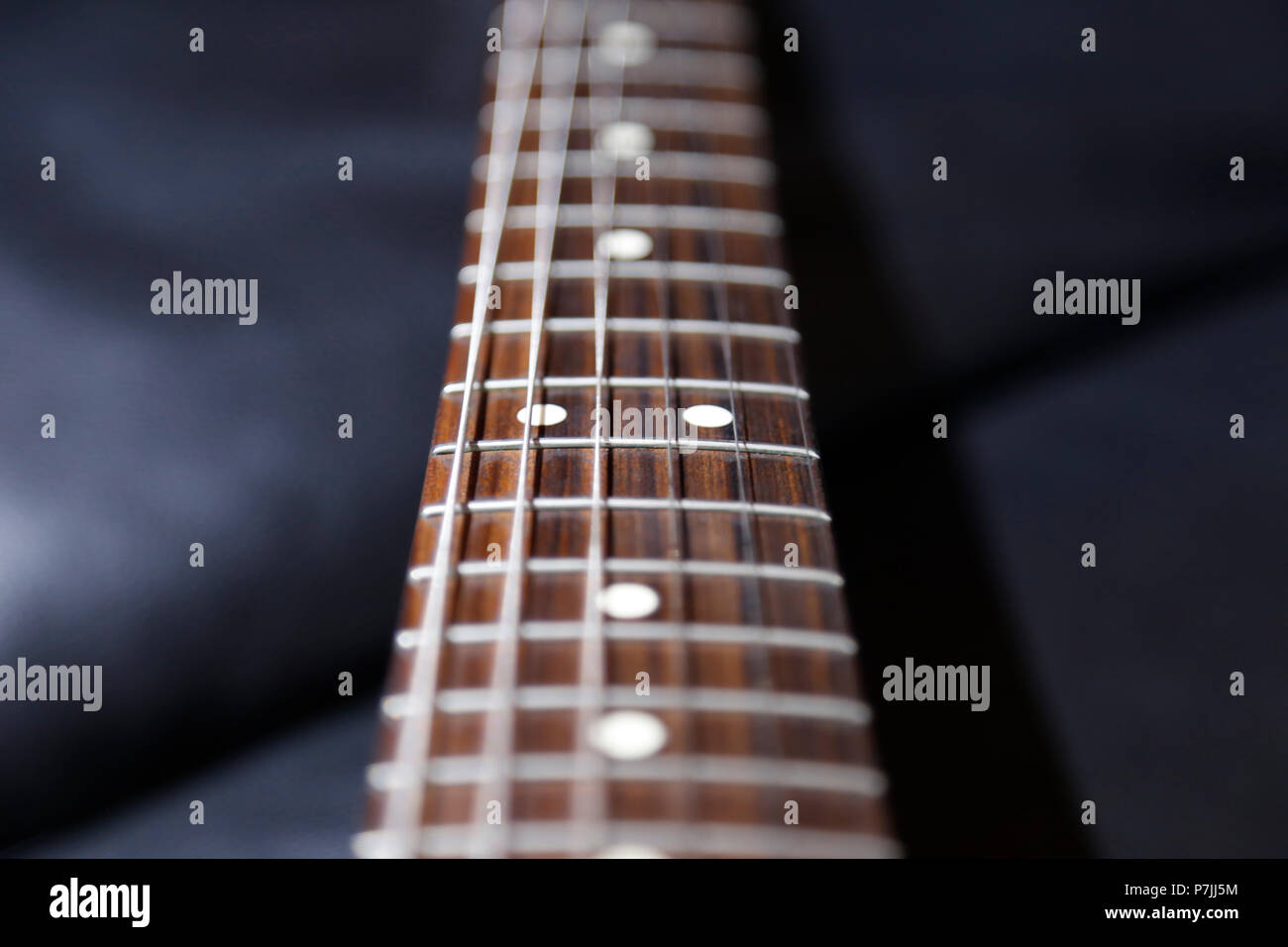 Detail of guitar neck and strings Stock Photo