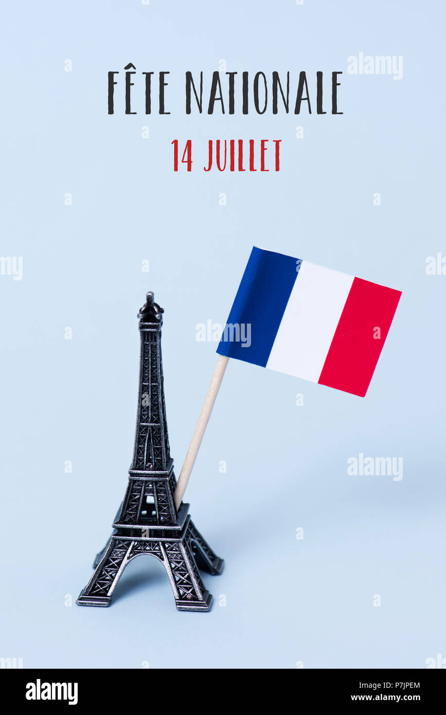 a miniature of the Eiffel Tower, a french flag and the text fete