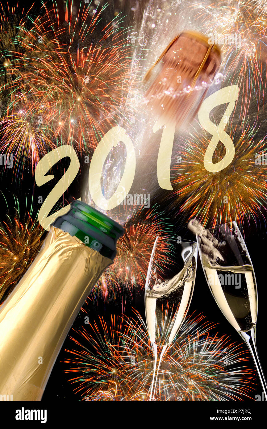 Champagne bottle with flying cork and fireworks on New Year's Eve 2018 Stock Photo