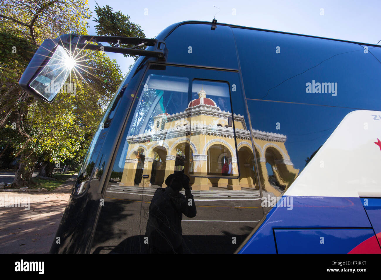 Grave site reflected in tour bus window at the Cementerio Cristobal Colon in Old Havana, Cuba. Stock Photo