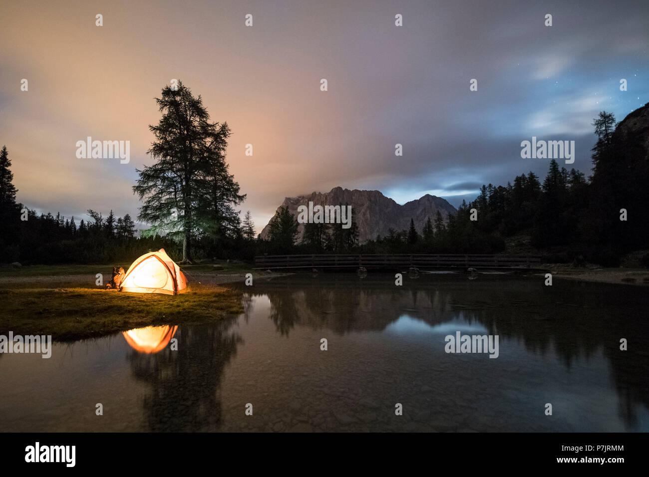 Camping at Lake Seebensee, illuminated tent with Zugspitze (peak) in