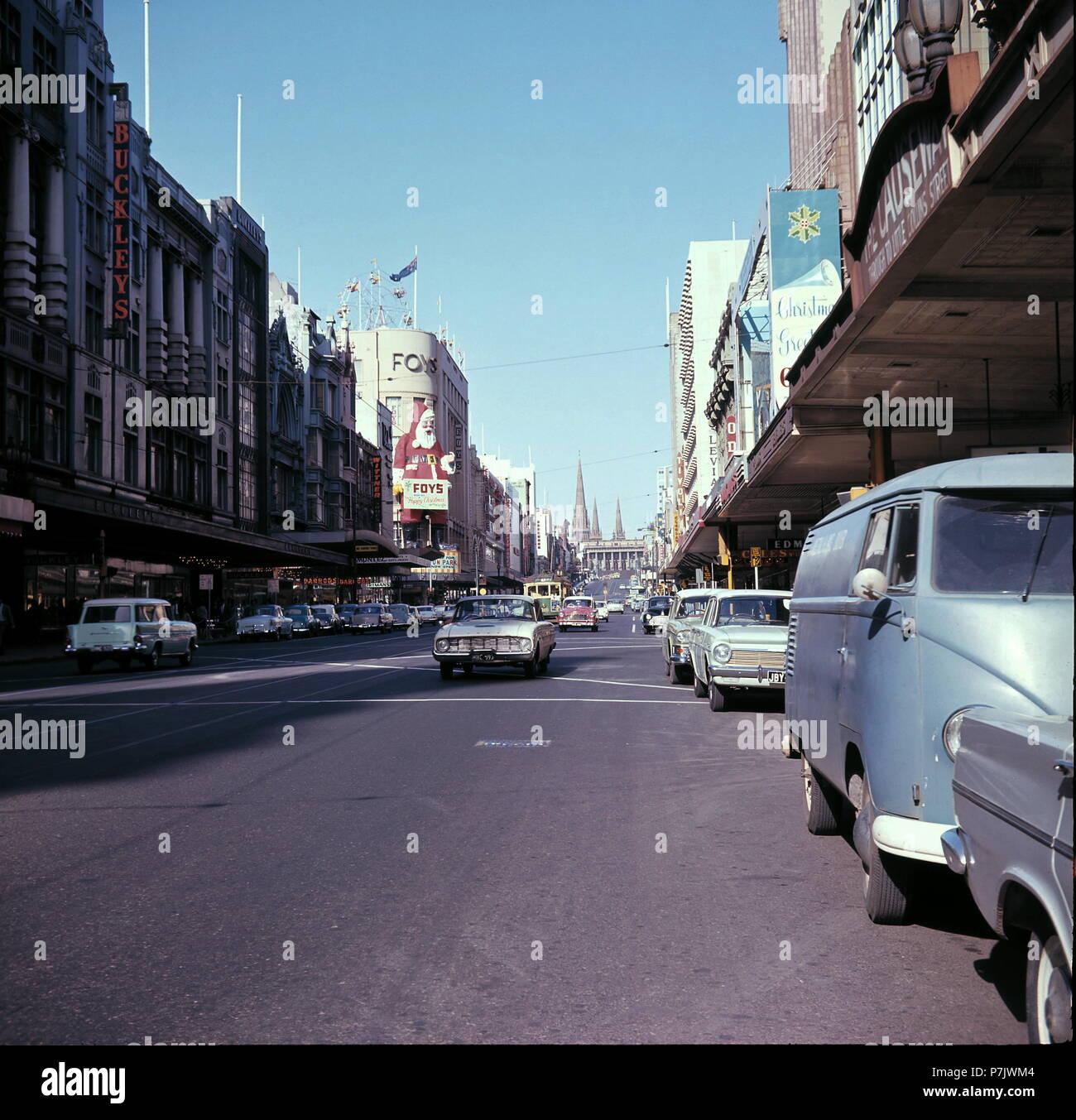AJAXNETPHOTO. 1964. MELBOURNE, AUSTRALIA. - BOURKE STREET LOOKING NORTH WEST - FOYS DEPARTMENT STORE VISIBLE ON THE LEFT WITH SANTA CLAUS PLACARD; BUCKLEY'S ON NEAR LEFT; THE CAUSEWAY ENTRANCE LEADING TO LITTLE COLLINS STREET EXTREME RIGHT ABOVE VOLKSWAGEN CAMPER VAN.  PHOTO:JONATHAN EASTLAND/AJAX REF:C65108 3 58 Stock Photo