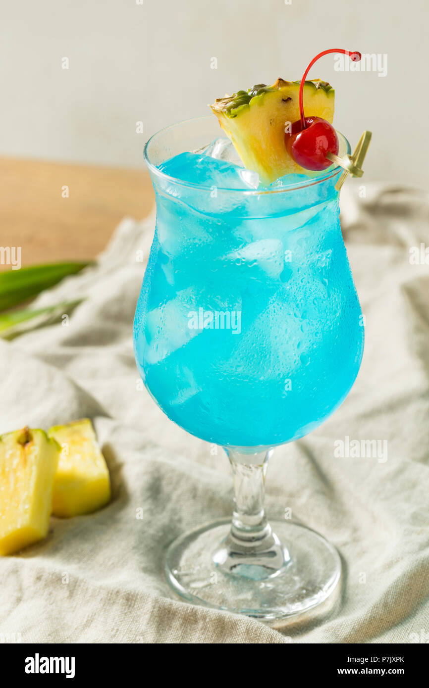 Boozy Blue Hawaii Hurricane Cocktail with Rum and Pineapple Stock Photo
