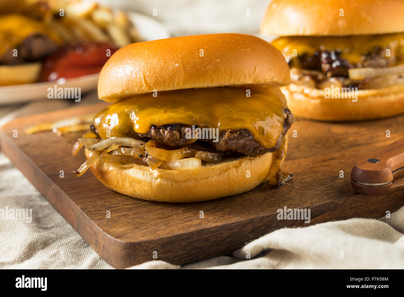 Homemade Oklahoma Fried Onion Cheeseburgers with Cheddar Stock Photo