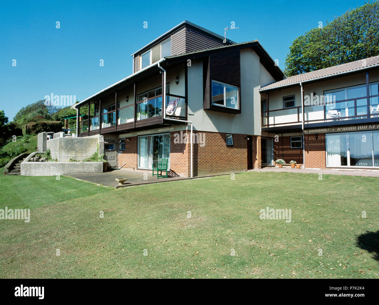 Lawn in front of large sixties-built house in the country Stock Photo