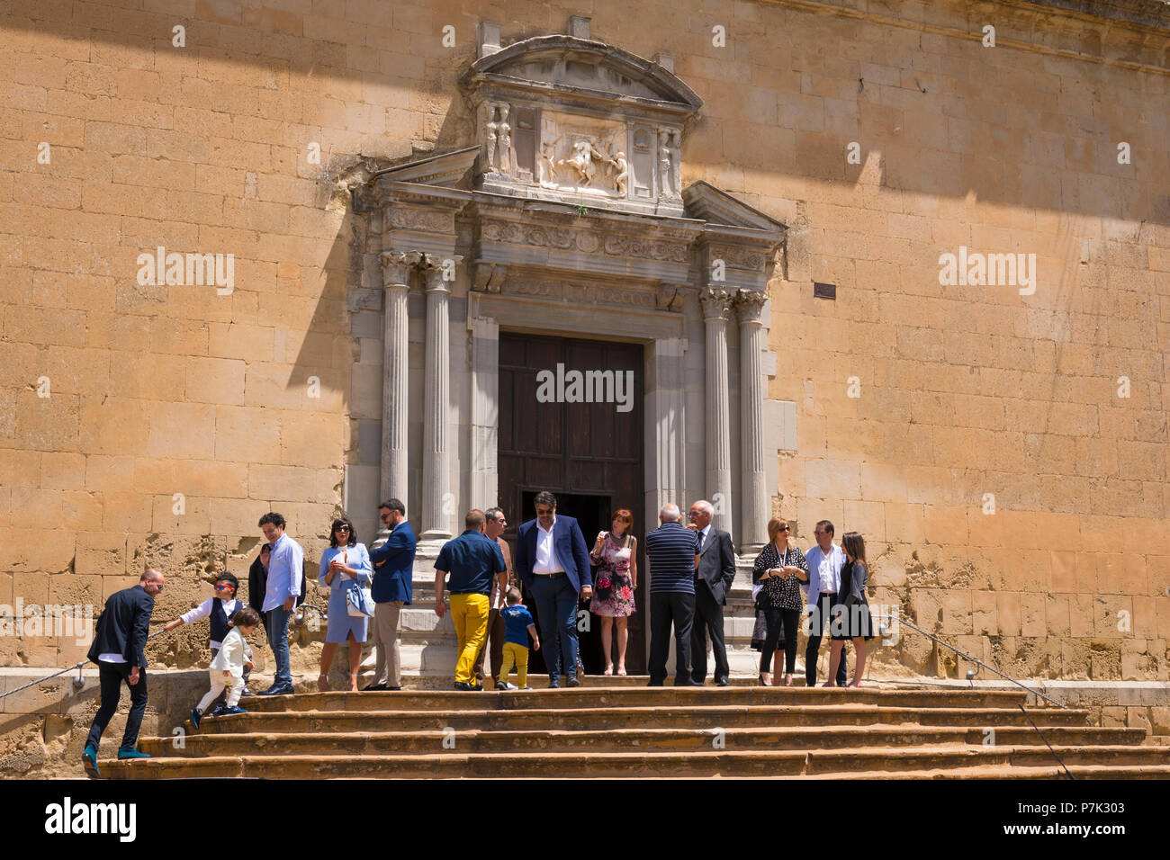 Italy Sicily old mountain town 931m 15th century Enna Cathedral Cattedrale Duomo Sunday Catholic Mass congregation leaving steps stairs side door Stock Photo