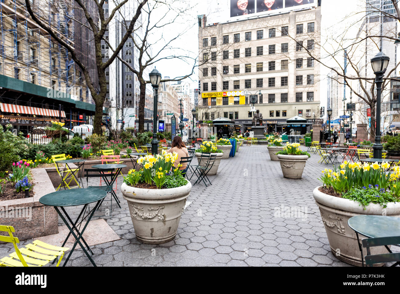 New York City, USA - April 7, 2018: Street view of urban NYC Herald Square Midtown with Greeley Square Park, woman sitting by korea town koreatown Stock Photo