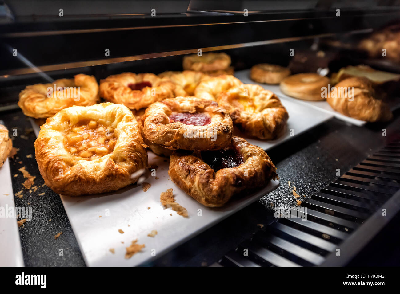 Closeup Of Many Yellow Dessert Berry Fruit Apple Baked Danish Pastries On Shelf Tray Display Desserts In Bakery Shop Cafe Store Dark Counter Stock Photo Alamy