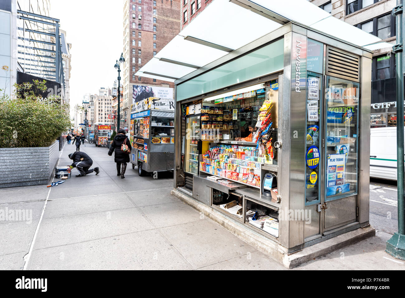 New York City, USA - April 7, 2018: Midtown Manhattan with street sidewalk on Broadway, Newsstand with newspaper, magazines, candy Stock Photo