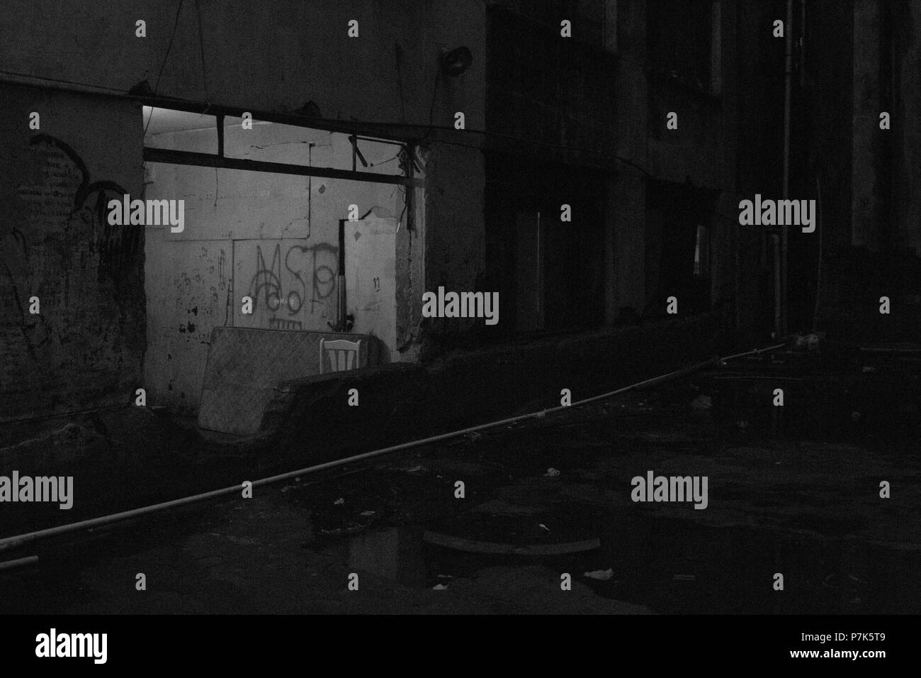 Huge window in now used as entrance in a condemned abandoned building
